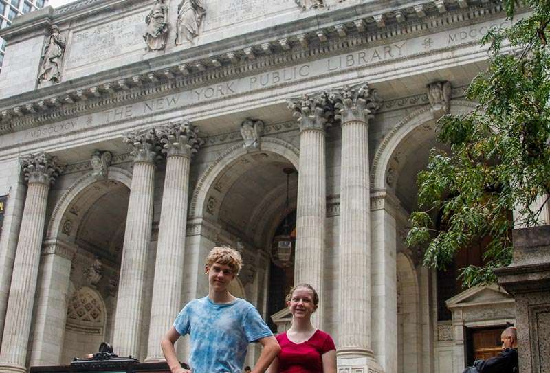 Kids in front of New York Public Library in New York City one of the Best places to travel with kids