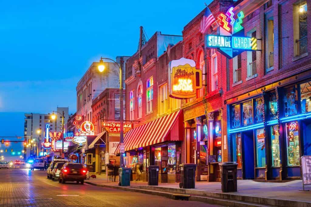 Family Vacation Ideas with Teenagers. picture of Memphis street at night with colorful neon signs