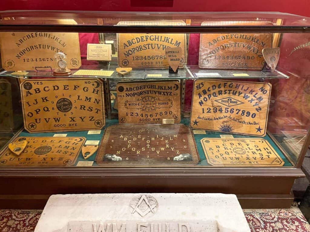Ouija Board museum display case of 9 different Ouija boards