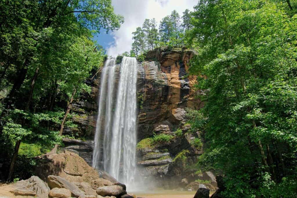 Green trees and Toccoa Falls free standing waterfall. A perfect hike for families in North Georgia. hikes in North Georgia.