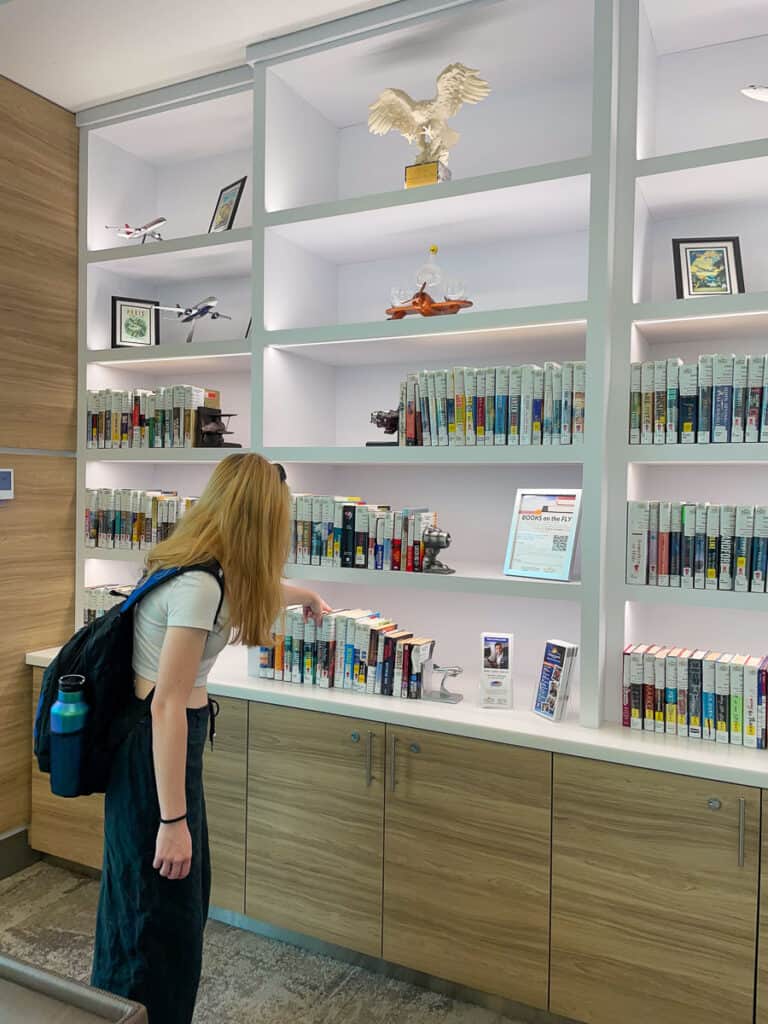 Daytona Beach International Airport Review, girl looking at books on a shelf