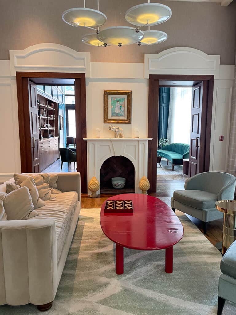 Lobby and library area of Perry Lane Hotel featuring art work, and stately furniture. Unique Places to Stay in Savannah Georgia