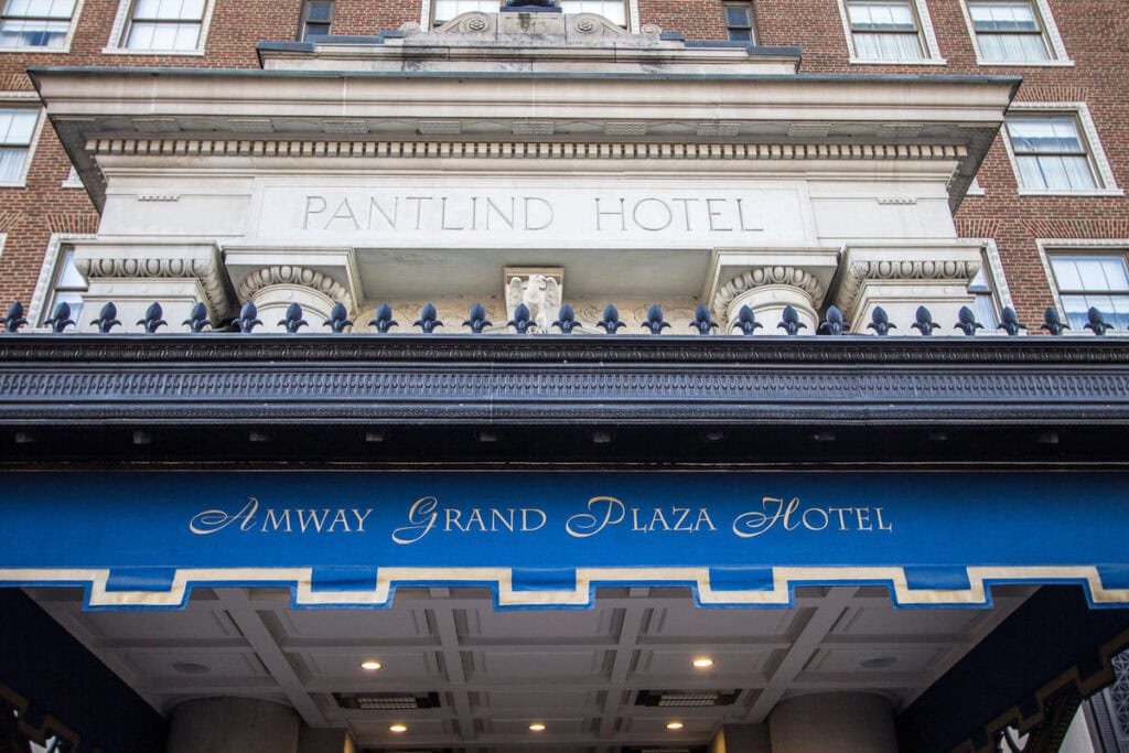 View of the Amway Grand Plaza Hotel entrance with a blue awning and the building’s former name, Pantlind Hotel, engraved above the doorway—an iconic spot when exploring things to do in Grand Rapids with teens.
